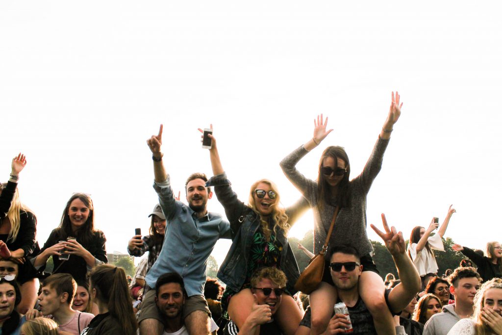 A group of people dancing at a festival. Alcohol and fun at the festivals. 