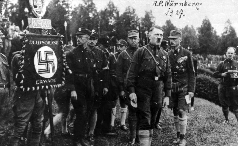 Depicted (left to right from the banner): Heinrich Himmler, Rudolf Hess, Gregor Strasser, Adolf Hitler, Franz von Pfeffer